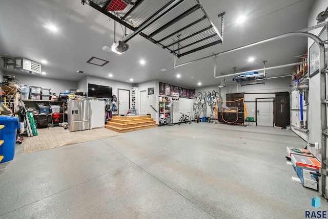 1301 S Hyannis Port Ln, Sioux Falls, SD 57106 - garage featuring stainless steel fridge and a garage door opener