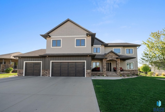 1301 S Hyannis Port Ln, Sioux Falls, SD 57106 - view of front facade featuring stone siding, driveway, board and batten siding, a front lawn, and a garage