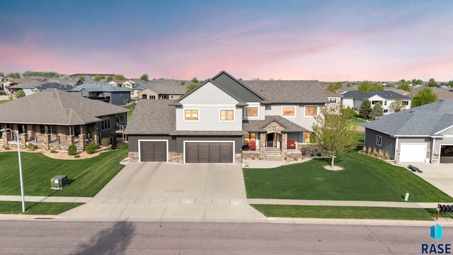1301 S Hyannis Port Ln, Sioux Falls, SD 57106 - view of front facade featuring a residential view, driveway, stone siding, and a front lawn