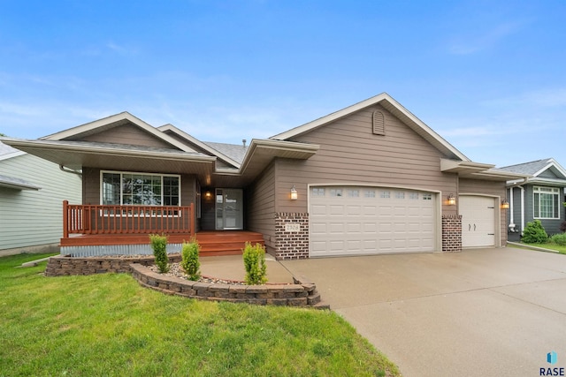7308 W 53rd St, Sioux Falls, SD 57106 - ranch-style home featuring an attached garage, driveway, brick siding, covered porch, and a front yard