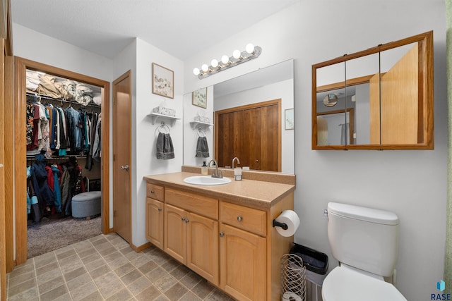 7308 W 53rd St, Sioux Falls, SD 57106 - bathroom featuring vanity, toilet, and a walk in closet