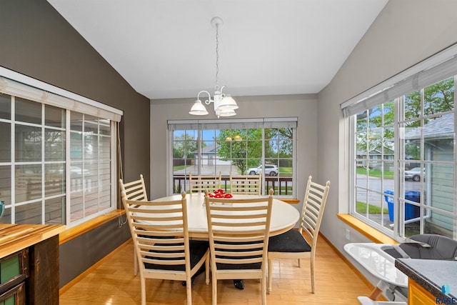 7308 W 53rd St, Sioux Falls, SD 57106 - dining room with a chandelier, plenty of natural light, light wood-style floors, and lofted ceiling
