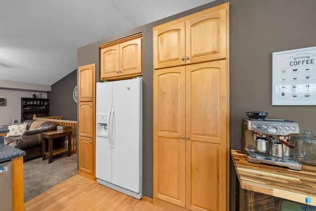 7308 W 53rd St, Sioux Falls, SD 57106 - kitchen with white fridge with ice dispenser, lofted ceiling, light wood-style floors, and dark countertops