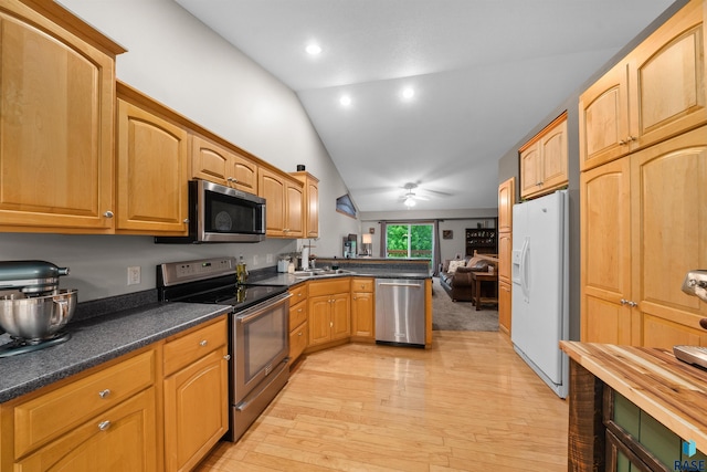 7308 W 53rd St, Sioux Falls, SD 57106 - kitchen with appliances with stainless steel finishes, vaulted ceiling, a peninsula, light wood finished floors, and ceiling fan