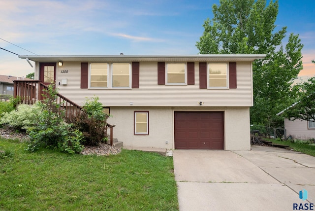 1300 S Point Dr, Sioux Falls, SD 57103 - view of front of property with stucco siding, driveway, an attached garage, and a front yard