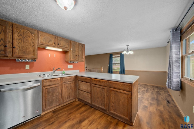 1300 S Point Dr, Sioux Falls, SD 57103 - kitchen featuring dishwasher, a sink, a peninsula, dark wood-style floors, and a textured ceiling