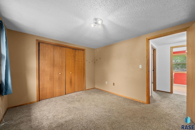 1300 S Point Dr, Sioux Falls, SD 57103 - unfurnished bedroom with a closet, carpet floors, a textured ceiling, and baseboards