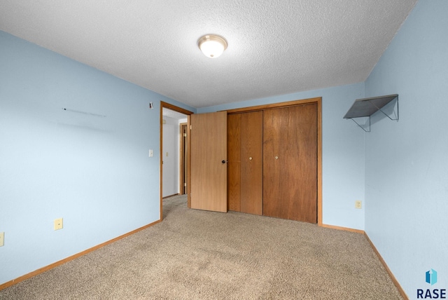 1300 S Point Dr, Sioux Falls, SD 57103 - unfurnished bedroom with carpet flooring, a closet, a textured ceiling, and baseboards