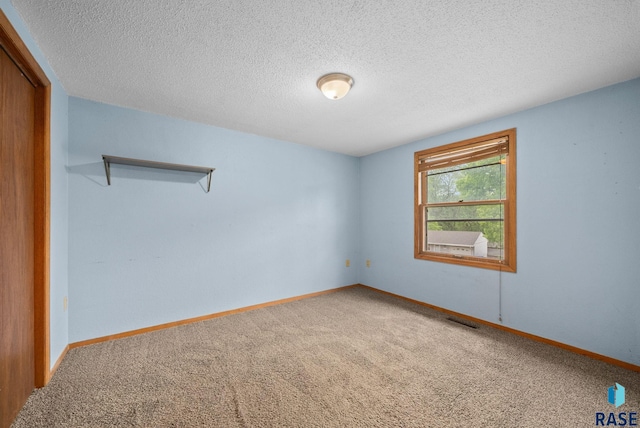 1300 S Point Dr, Sioux Falls, SD 57103 - empty room with carpet flooring, a textured ceiling, and baseboards