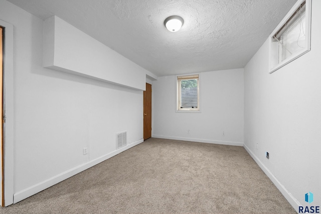 1300 S Point Dr, Sioux Falls, SD 57103 - additional living space featuring a textured ceiling, carpet floors, and baseboards