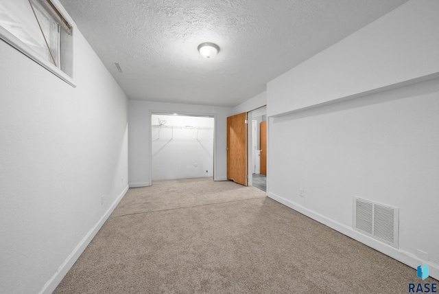 1300 S Point Dr, Sioux Falls, SD 57103 - unfurnished bedroom with carpet floors, a textured ceiling, and baseboards