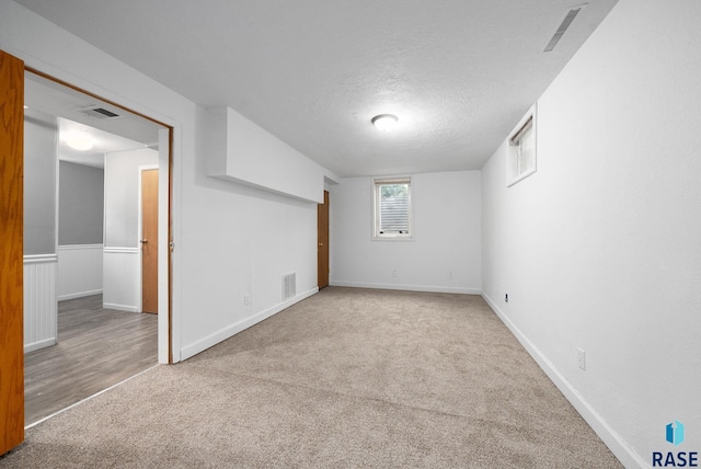 1300 S Point Dr, Sioux Falls, SD 57103 - basement with carpet flooring, baseboards, and a textured ceiling