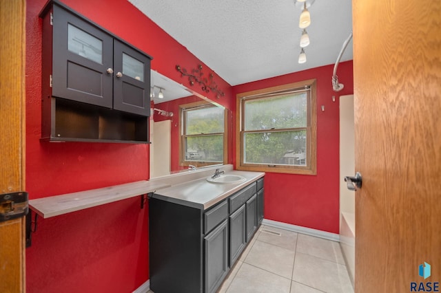 1300 S Point Dr, Sioux Falls, SD 57103 - kitchen featuring a sink, light tile patterned floors, light countertops, baseboards, and track lighting