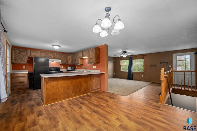 1300 S Point Dr, Sioux Falls, SD 57103 - kitchen featuring black appliances, dark wood-style floors, a peninsula, and open floor plan