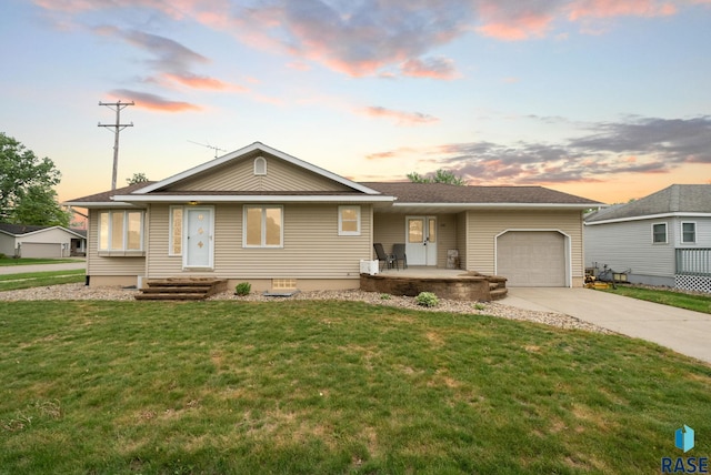 350 W Maple St, Edgerton, MN 56128 - view of front facade with an attached garage, driveway, and a front yard