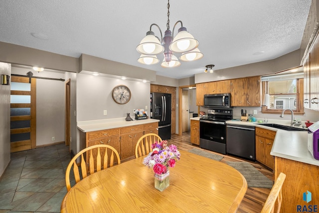 350 W Maple St, Edgerton, MN 56128 - dining room featuring a barn door, a chandelier, and a textured ceiling