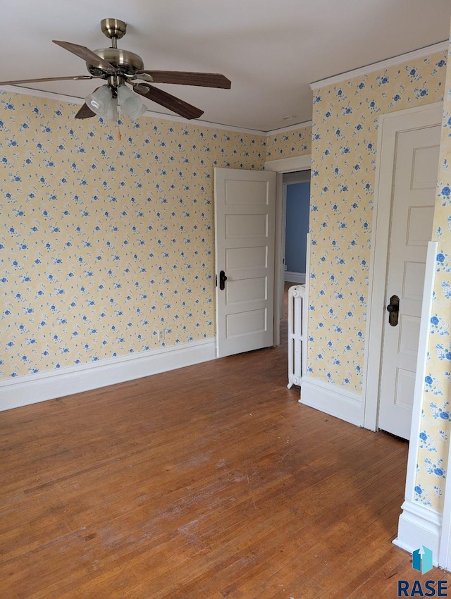 302 E 19th St, Sioux Falls, SD 57105 - empty room featuring wallpapered walls, wood finished floors, ceiling fan, ornamental molding, and baseboards