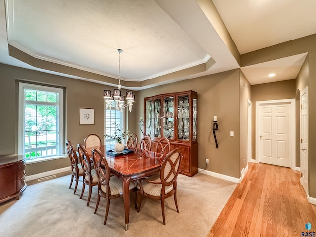 108 W Hazeltine Ln, Sioux Falls, SD 57108 - dining space featuring a tray ceiling, a chandelier, baseboards, ornamental molding, and light wood-type flooring
