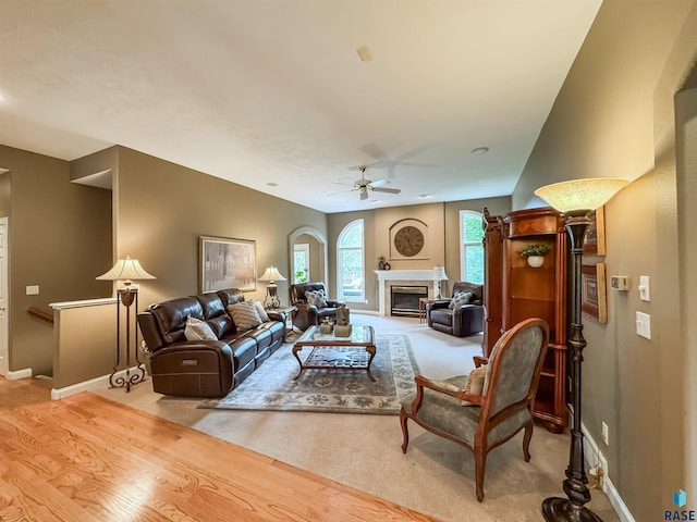 108 W Hazeltine Ln, Sioux Falls, SD 57108 - living area featuring ceiling fan, baseboards, light carpet, and a glass covered fireplace