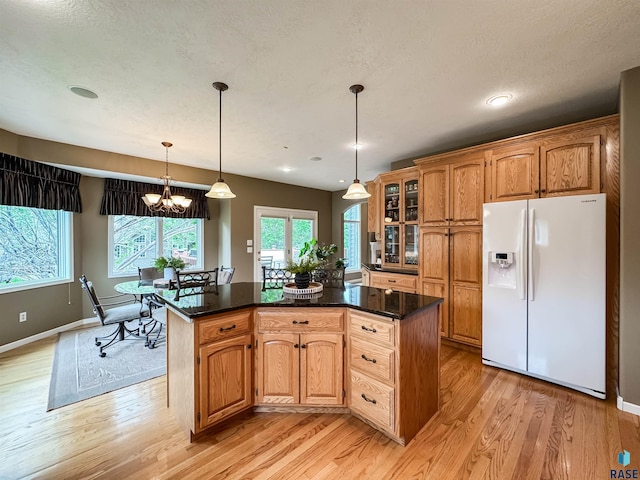 108 W Hazeltine Ln, Sioux Falls, SD 57108 - kitchen featuring white fridge with ice dispenser, light wood-style floors, baseboards, glass insert cabinets, and recessed lighting