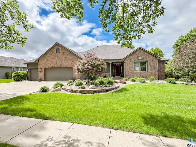 108 W Hazeltine Ln, Sioux Falls, SD 57108 - view of front facade featuring brick siding, a garage, a front lawn, and driveway