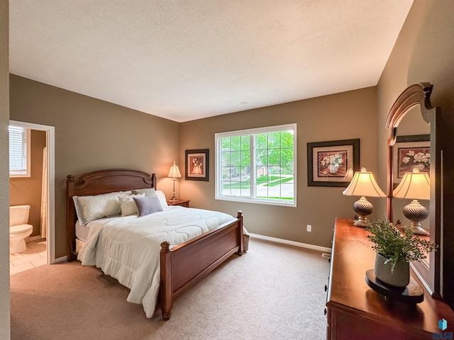 108 W Hazeltine Ln, Sioux Falls, SD 57108 - bedroom with light colored carpet, baseboards, and ensuite bath