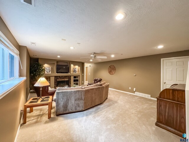 108 W Hazeltine Ln, Sioux Falls, SD 57108 - living room with a premium fireplace, baseboards, light carpet, a ceiling fan, and recessed lighting