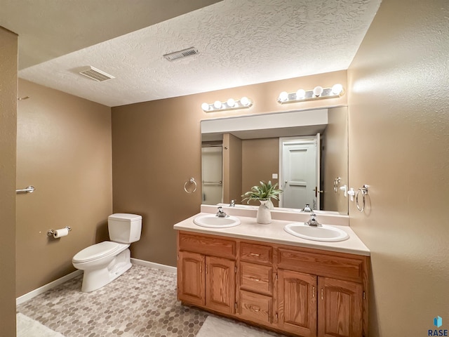 108 W Hazeltine Ln, Sioux Falls, SD 57108 - bathroom featuring double vanity, toilet, baseboards, and a textured ceiling