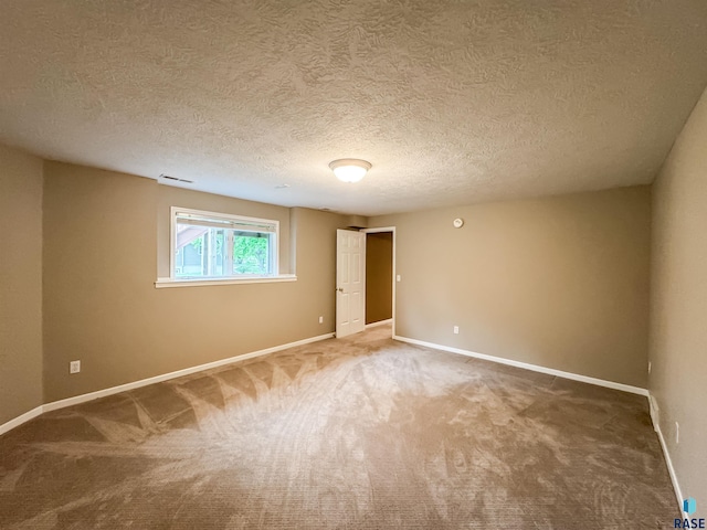 108 W Hazeltine Ln, Sioux Falls, SD 57108 - empty room with carpet floors, baseboards, and a textured ceiling