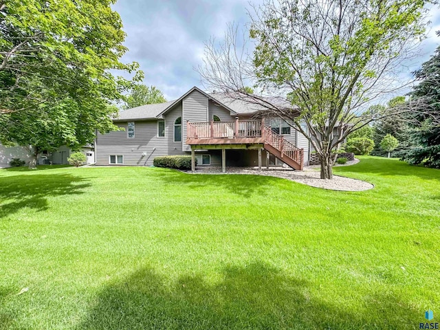 108 W Hazeltine Ln, Sioux Falls, SD 57108 - back of property featuring a wooden deck, stairs, a lawn, and a shingled roof