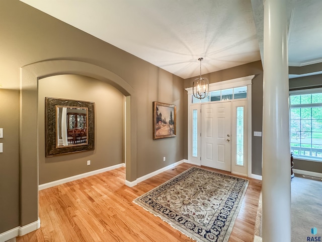 108 W Hazeltine Ln, Sioux Falls, SD 57108 - foyer featuring a chandelier, light wood-type flooring, baseboards, and arched walkways