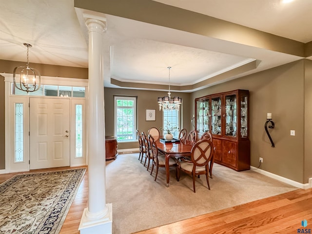 108 W Hazeltine Ln, Sioux Falls, SD 57108 - dining area featuring a chandelier, baseboards, a tray ceiling, crown molding, and light wood finished floors