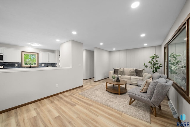 1912 E Sylvan Cir, Brandon, SD 57005 - living area featuring light wood finished floors, recessed lighting, and baseboards