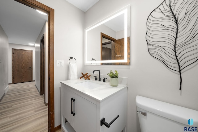 1912 E Sylvan Cir, Brandon, SD 57005 - half bathroom with wood finished floors, vanity, and toilet