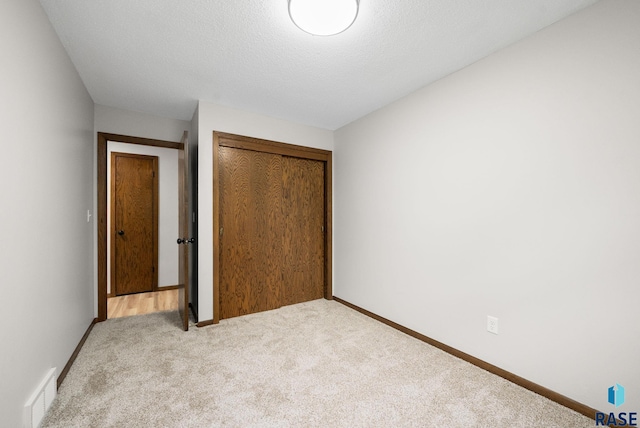 1912 E Sylvan Cir, Brandon, SD 57005 - unfurnished bedroom with carpet floors, a closet, and baseboards