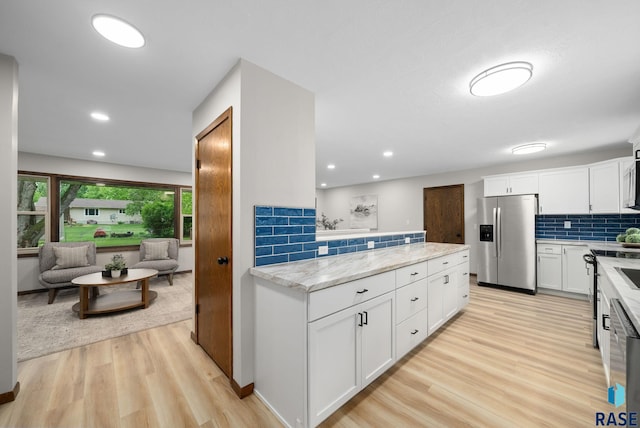 1912 E Sylvan Cir, Brandon, SD 57005 - kitchen with stainless steel fridge with ice dispenser, light wood-style floors, white cabinetry, tasteful backsplash, and recessed lighting