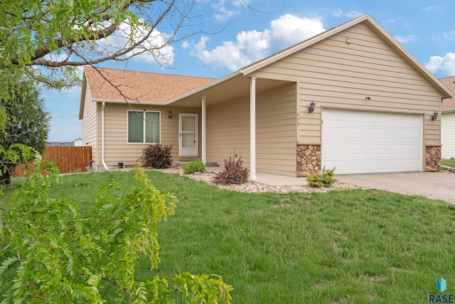 605 N Daisy Ave, Sioux Falls, SD 57107 - ranch-style home with an attached garage, concrete driveway, a shingled roof, and stone siding