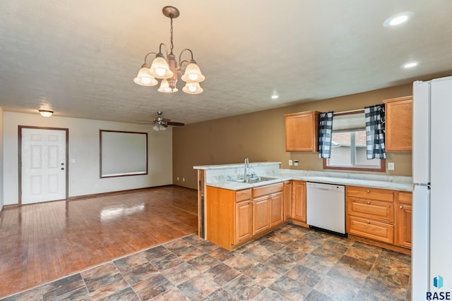 605 N Daisy Ave, Sioux Falls, SD 57107 - kitchen with white appliances, a sink, a peninsula, ceiling fan, and light countertops