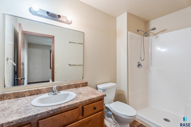 605 N Daisy Ave, Sioux Falls, SD 57107 - bathroom featuring toilet, a shower, and vanity