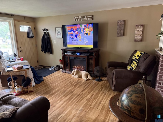822 S Jessica Ave, Sioux Falls, SD 57103 - living area with a glass covered fireplace and light wood-style floors