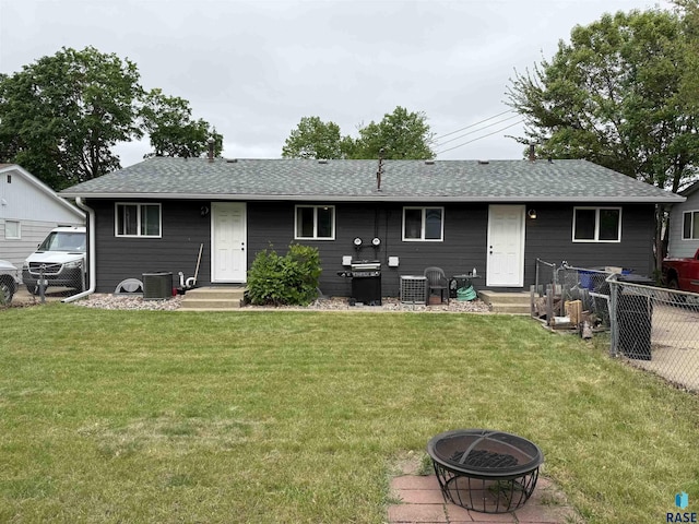 822 S Jessica Ave, Sioux Falls, SD 57103 - back of house with central AC, an outdoor fire pit, entry steps, and a shingled roof