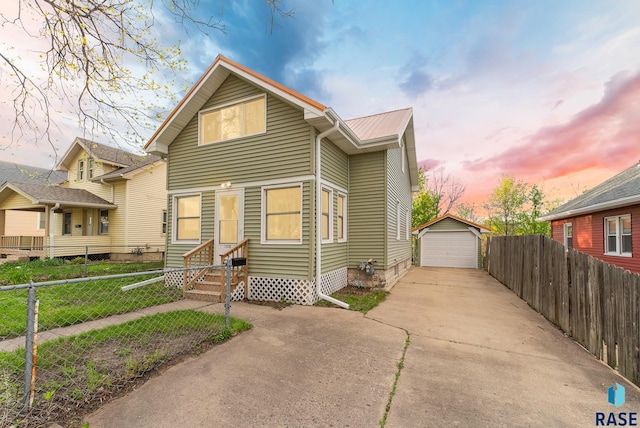 1530 W 10th St, Sioux Falls, SD 57104 - view of front facade with concrete driveway, an outbuilding, a garage, entry steps, and metal roof