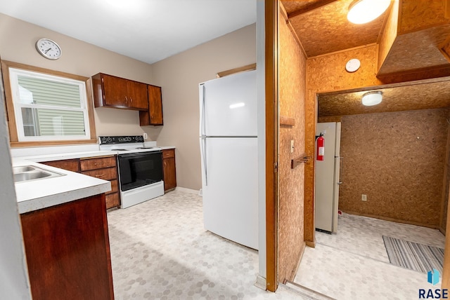 1530 W 10th St, Sioux Falls, SD 57104 - kitchen featuring freestanding refrigerator, range with electric cooktop, a sink, light countertops, and brown cabinetry