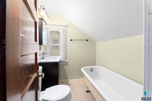 1530 W 10th St, Sioux Falls, SD 57104 - full bath featuring lofted ceiling, a freestanding tub, vanity, baseboards, and toilet