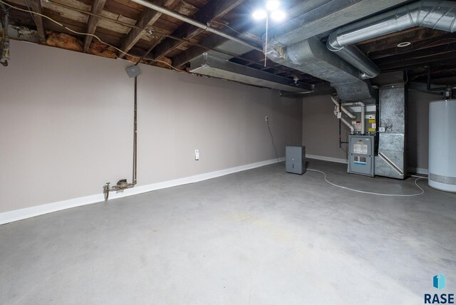 1530 W 10th St, Sioux Falls, SD 57104 - basement with gas water heater, heating unit, and baseboards