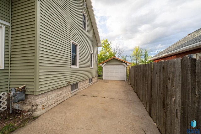 1530 W 10th St, Sioux Falls, SD 57104 - view of property exterior featuring concrete driveway, an outbuilding, and a garage