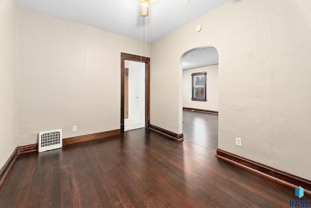 1530 W 10th St, Sioux Falls, SD 57104 - spare room featuring arched walkways, wood finished floors, and baseboards