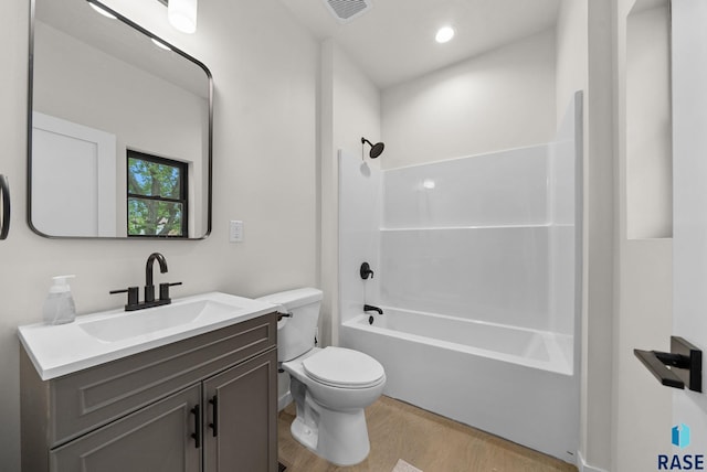 1709 S Duluth Ave, Sioux Falls, SD 57105 - full bath with wood finished floors, toilet, vanity, and shower / bathtub combination