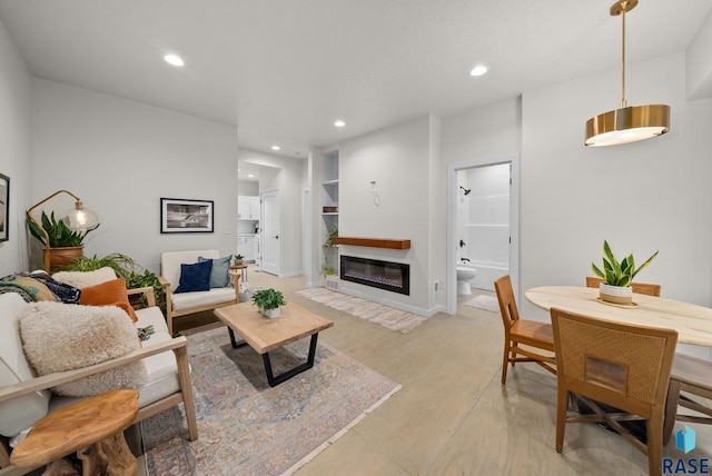 1709 S Duluth Ave, Sioux Falls, SD 57105 - living room featuring recessed lighting, built in shelves, a glass covered fireplace, and baseboards