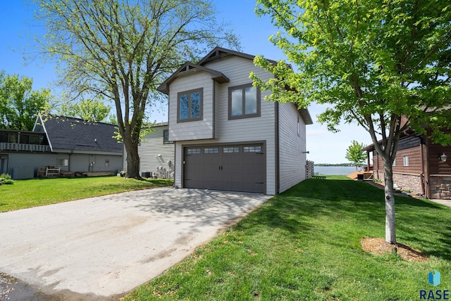 6604 Peninsula Pt, Wentworth, SD 57075 - view of front facade featuring an attached garage, a front lawn, concrete driveway, and a water view